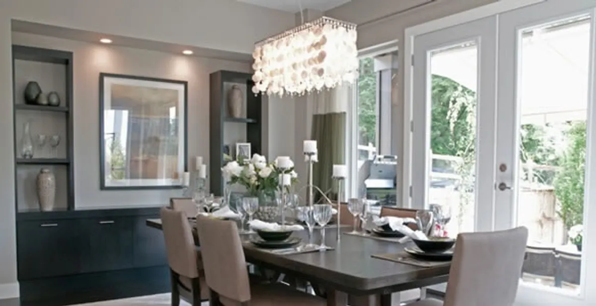Elegant dining room chandelier installation above table in Seattle, WA