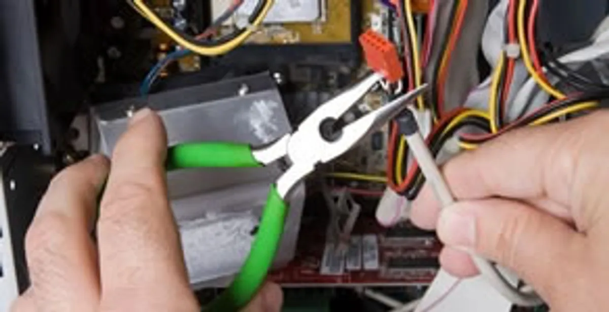 Licensed electrical contractor performing electrical repair with tools in Medina, WA