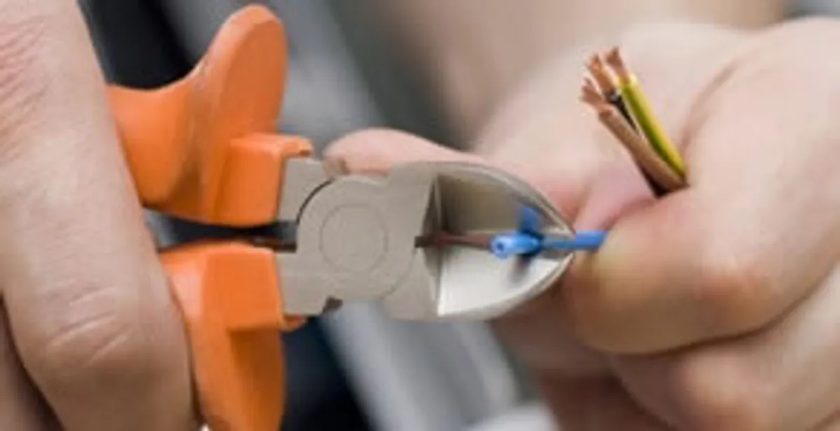professional electrical services showing precise wire cutting by licensed electricians in Seattle, WA